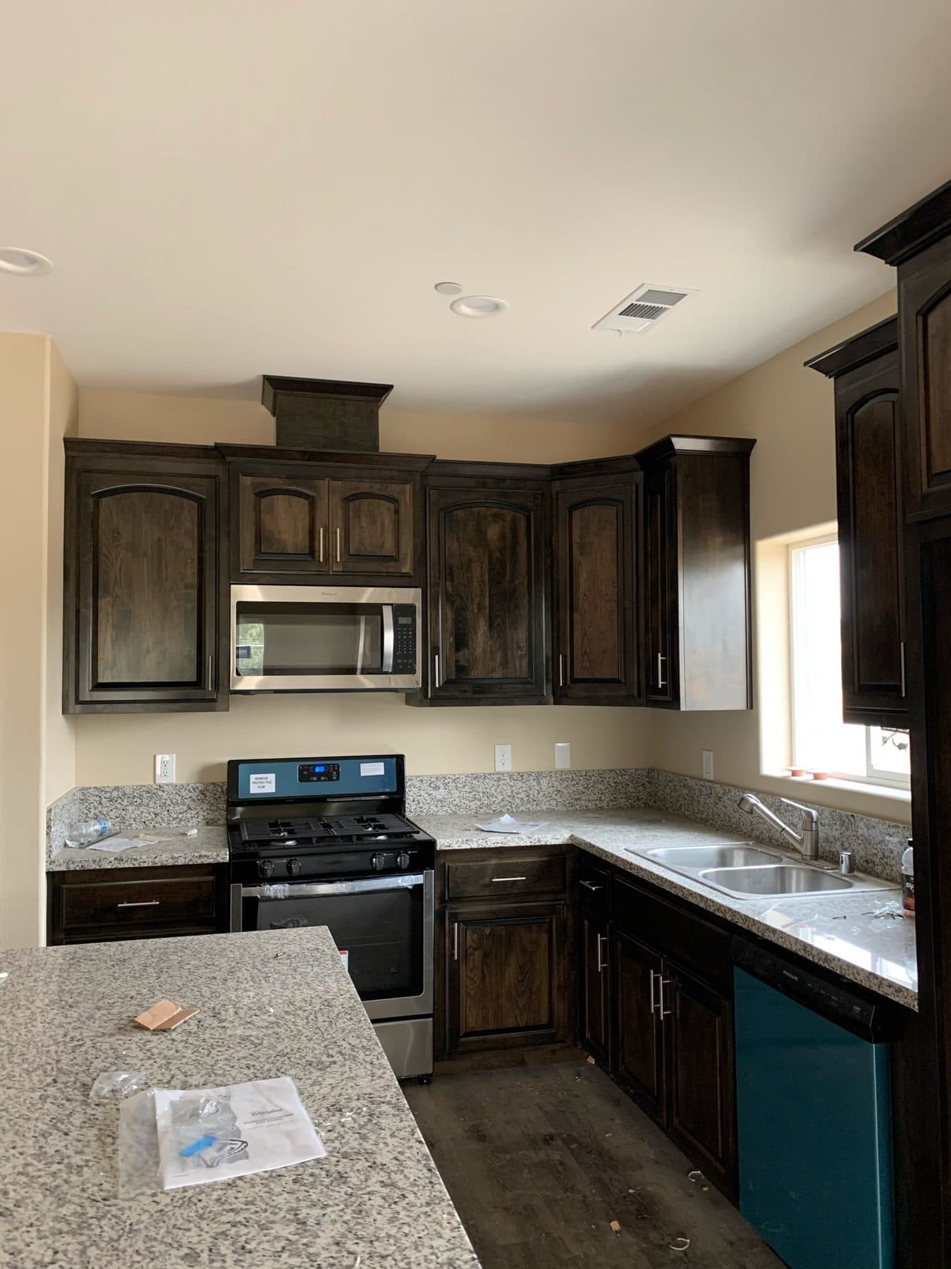 Dark-stained kitchen with granite