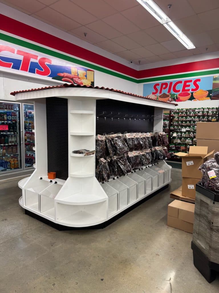 Bulk candy island with tile-roof canopy, pegboard and acrylic bins