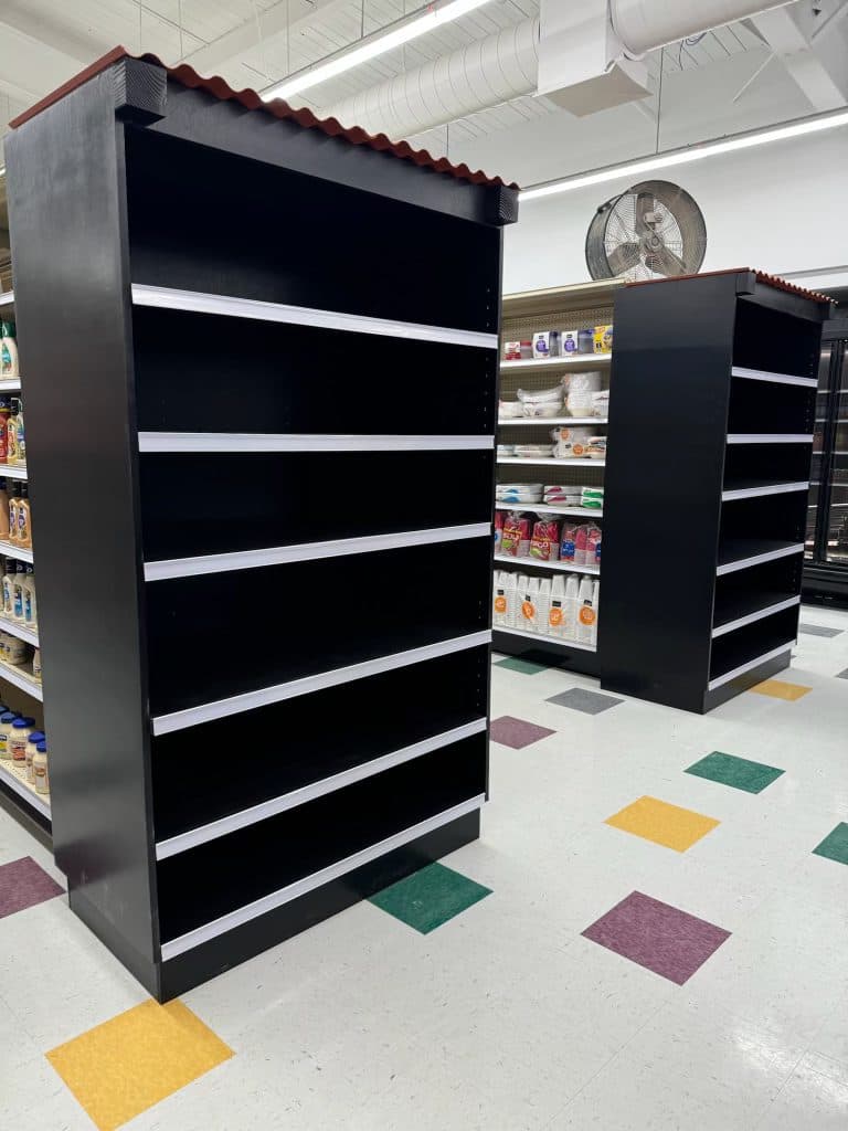 Black gondola shelving with tile-roof cap