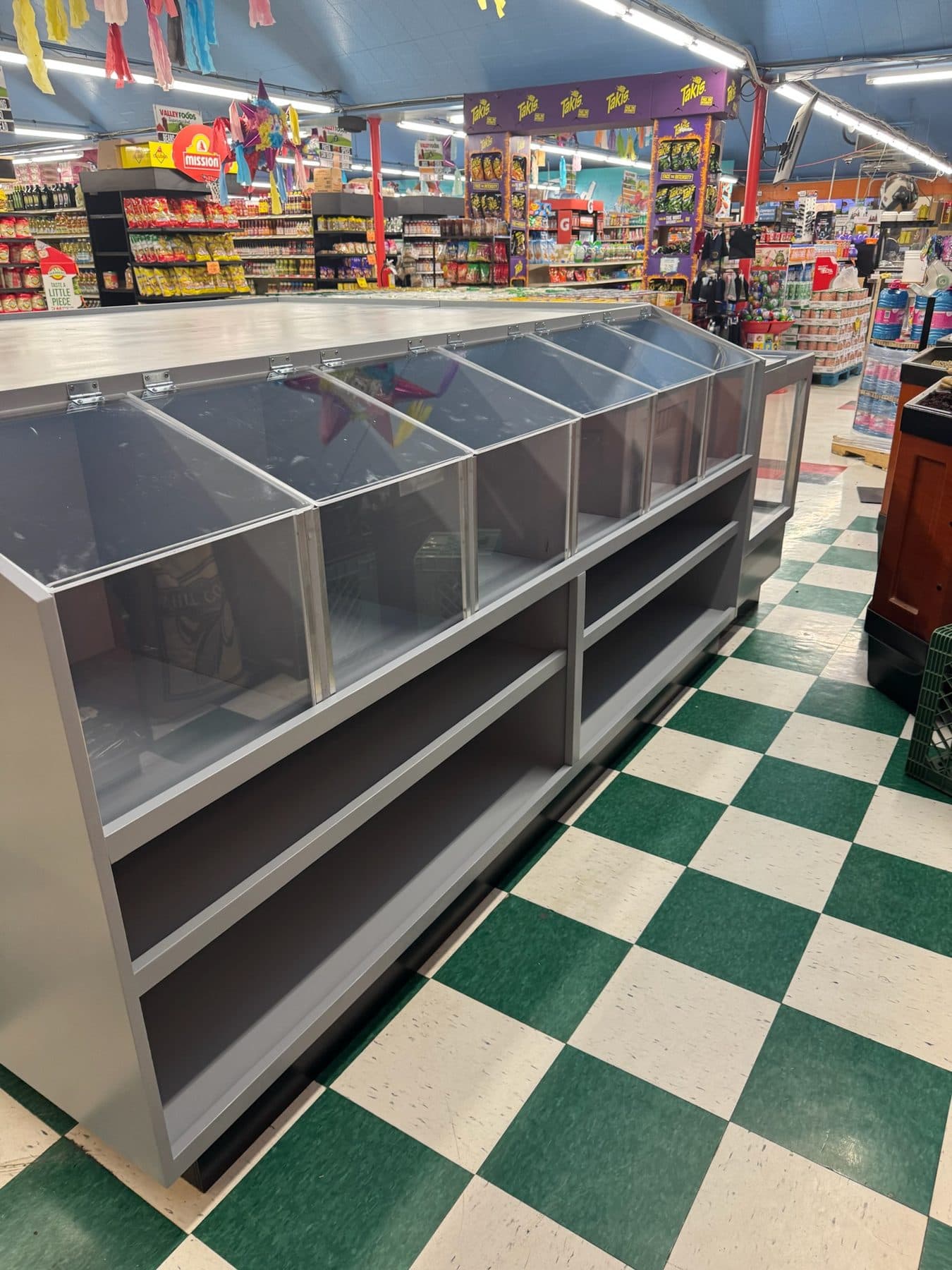 Grey bulk-bin display with acrylic fronts