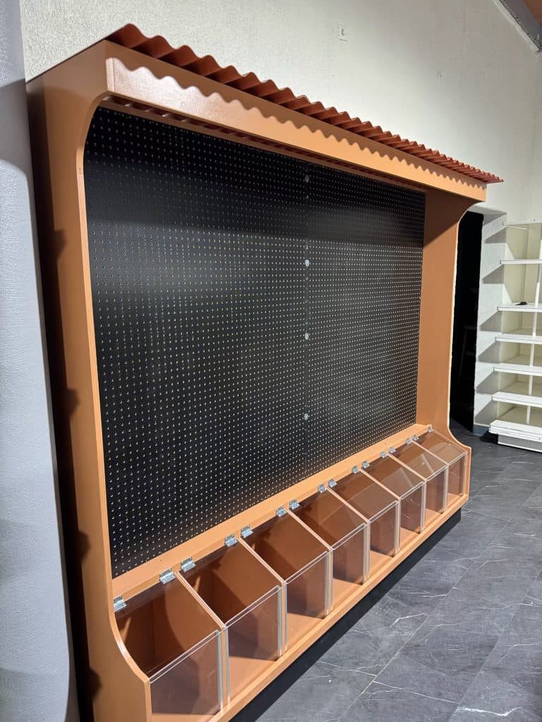Pegboard wall unit with acrylic bins and tile-roof trim