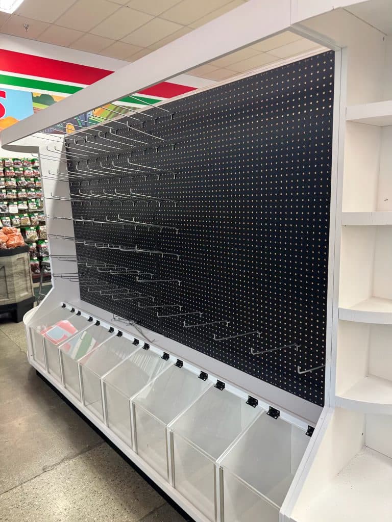 White pegboard display with acrylic bins
