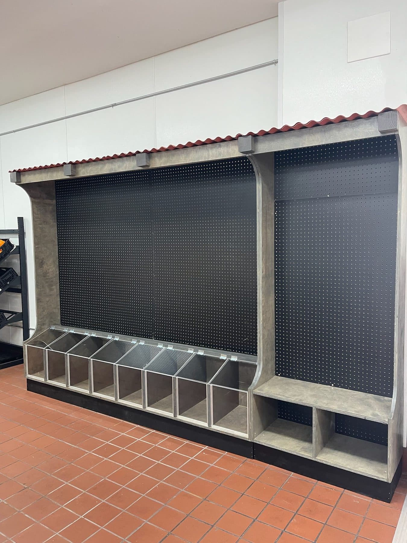Pegboard display with tile-roof canopy