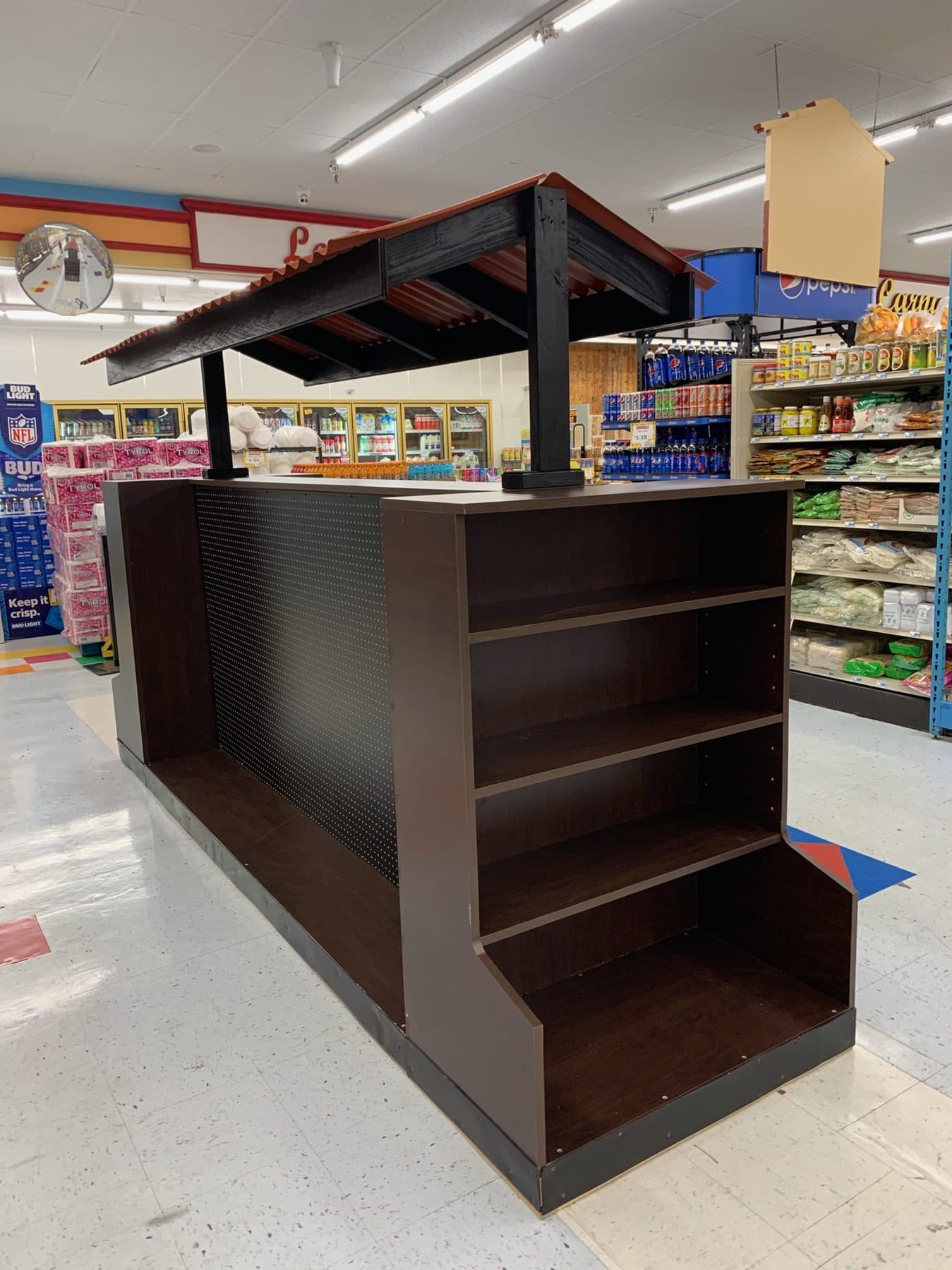 Dark-stained display island with canopy